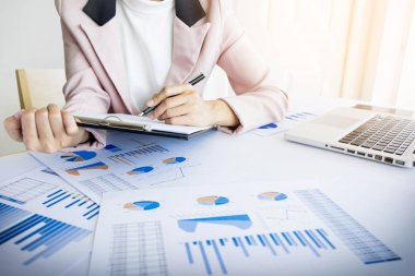 Portrait of business woman with laptop, finance graph and writes clipart