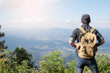 Sırt çantası ile kayalık mou açık rahatlatıcı ile genç adam Traveler