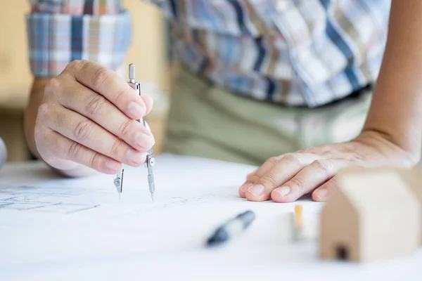 Крупним планом план малювання руки людини на синьому друку з архітектором — стокове фото