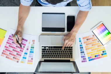 Bir masaüstü yüklü üzerinde çalışan bir genç grafik tasarımcı Üstten Görünüm