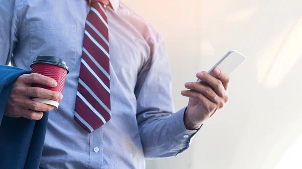 Businessman reading message on smartphone — Stock Photo, Image