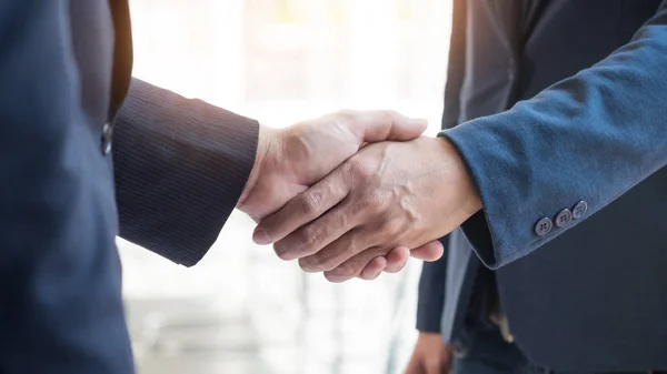 Two confident business man shaking hands during a meeting in the — Stock Photo, Image