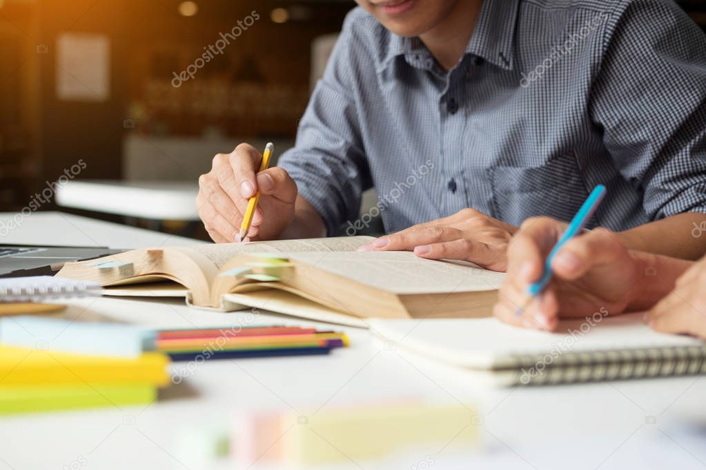 Young woman and man studying for a test/ an exam. Tutor books wi