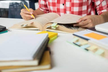 Genç kadın ve erkek bir test için eğitim / bir sınav. Öğretmen kitapları wi