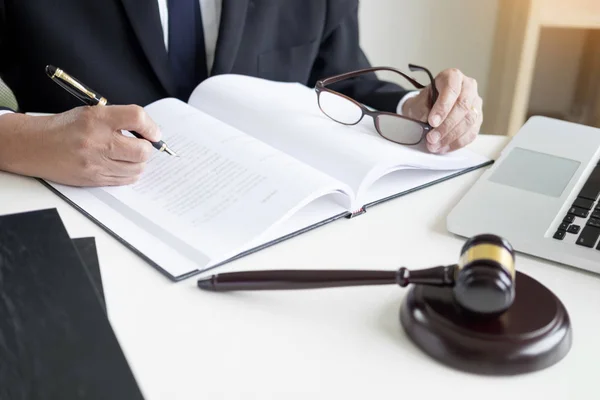 Lawyer hand writes the document in court (justice, law) with sou — Stock Photo, Image