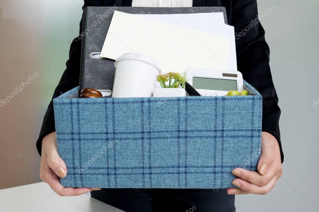 business woman packing personal company belongings when she deci