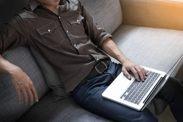 Businessman works on the sofa at home. Work searching for new id