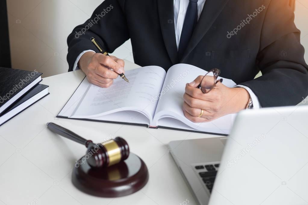 lawyer hand writes the document in court (justice, law) with sou