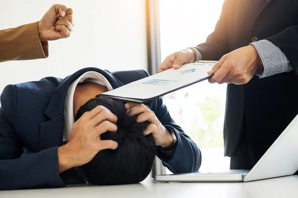 Group Of Angry Business people Blaming Male Colleague In Meeting