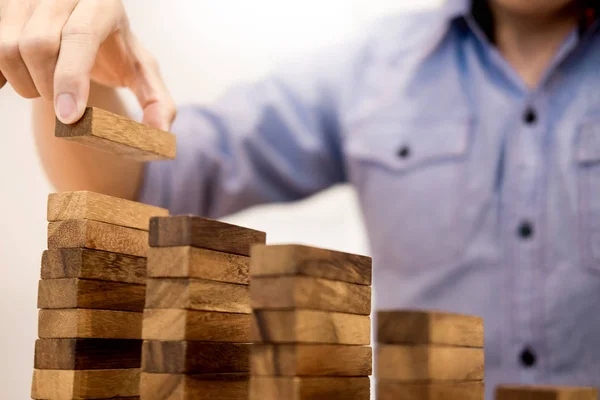 Business man hand put wooden blocks arranging stacking for devel — Stock Photo, Image