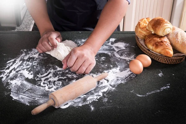 Woman\'s hands knead dough with flour, eggs and ingredients. at k