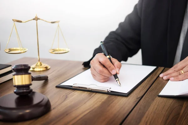 Lawyer hand writes the document in court (justice, law) with sou — Stock Photo, Image