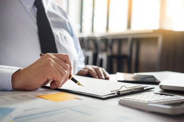 Dizüstü bilgisayar, tablet ve grafik dat ile ofisinde çalışan iş adamı