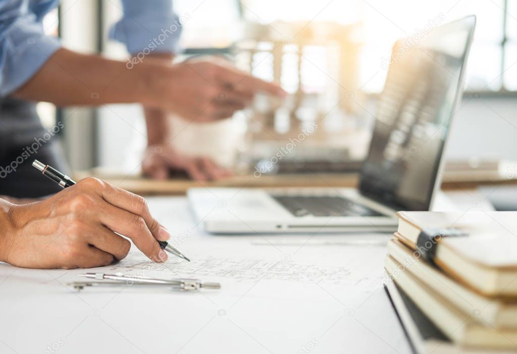 Close-up Of Person's engineer Hand Drawing Plan On Blue Print wi