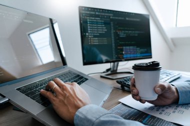 Programmer Typing Code on desktop computer, Developing programmi