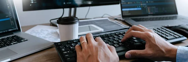 Programmer Typing Code on desktop computer, Developing programmi — Stockfoto