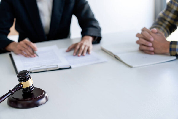 business people and lawyers discussing contract papers sitting a