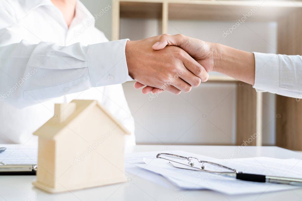 House developers and customer shaking hand after finish buying or rental real estate for transfer right of property.