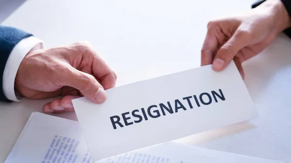 Businessman sending resignation letter to the executive employer boss on desk in order to resign dismiss contract, job placement and vacancies concept