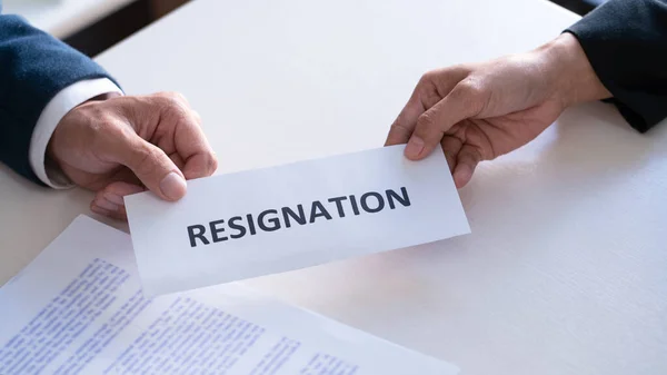 Businessman sending resignation letter to the executive employer boss on desk in order to resign dismiss contract, job placement and vacancies concept