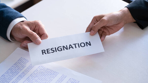 Businessman sending resignation letter to the executive employer boss on desk in order to resign dismiss contract, job placement and vacancies concept