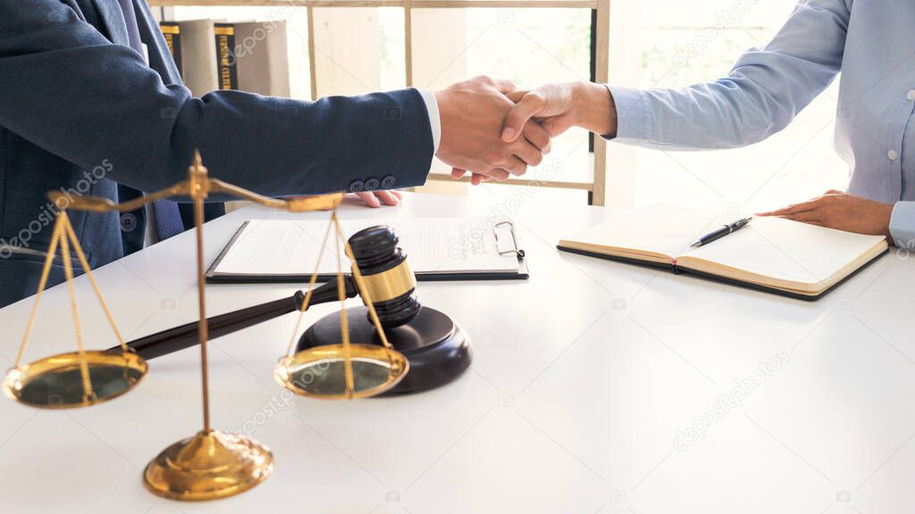 Handshake after cooperation between attorneys lawyer and clients discussing a contract agreement hope of victory over legal fighters  Concepts of law  advice