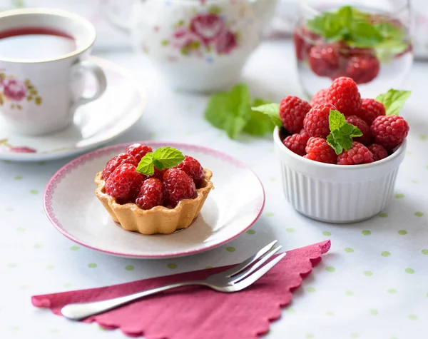 Cupcake with raspberries, mint on a table — Stock Photo, Image