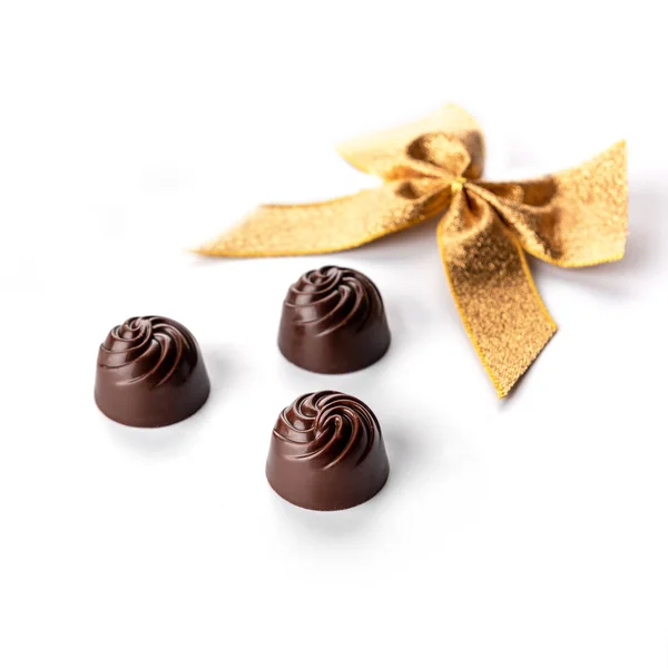 Pralinés Chocolate Fundo Branco Com Fita Dourada — Fotografia de Stock
