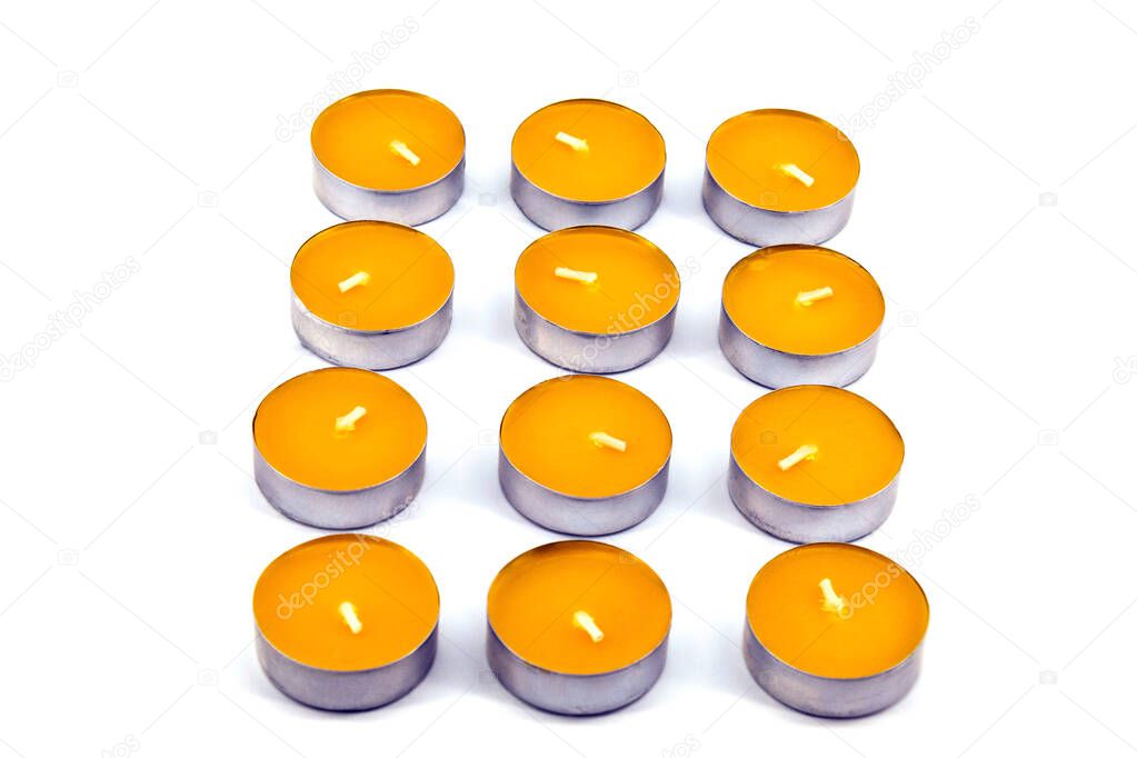 Unlit candles with the scent of mango was lying on a white background
