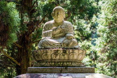 Buddhist sculpture in the Okunoin cemetery in Koyasan Mount Koya, UNESCO world heritage site and a 1200 years old center of Japanese sect of of Shingon Buddhism, Japan clipart