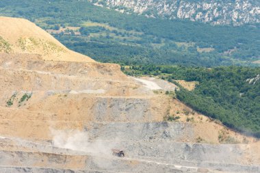 Bor / Serbia - July 13, 2019: Damper truck transporting ore in the Veliki Krivelj mine of Zijin Bor Copper, one of the largest copper mines in the world, owned by Chinese mining company Zijin Mining clipart