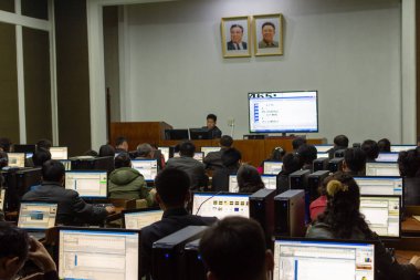 Pyongyang / DPR Kore - 12 Kasım 2015: Öğrenciler, Pyongyang 'daki tüm Kuzey Korelilere açık bir eğitim merkezi olan Grand People' s Study House 'daki bir bilgisayar çalışma odasında program öğreniyor