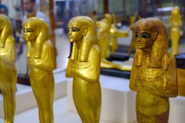Cairo / Egypt - May 25th 2019: Golden statuettes depicting pharaoh, Museum of Egyptian Antiquities (Egyptian Museum) clipart