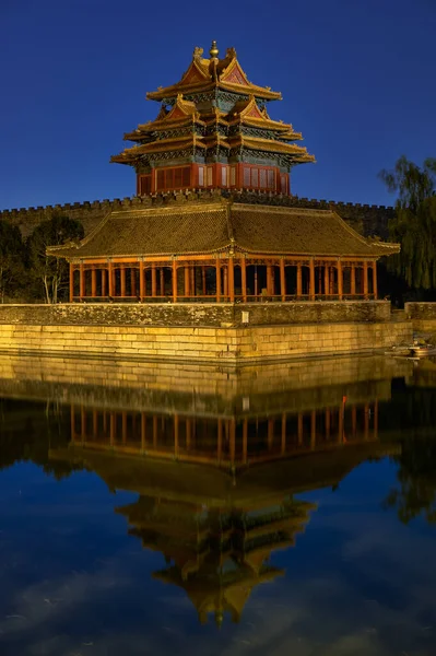 Northwestern tower of the Forbidden City Palace Museum in Beijing, China, reflecting in the water moat at night