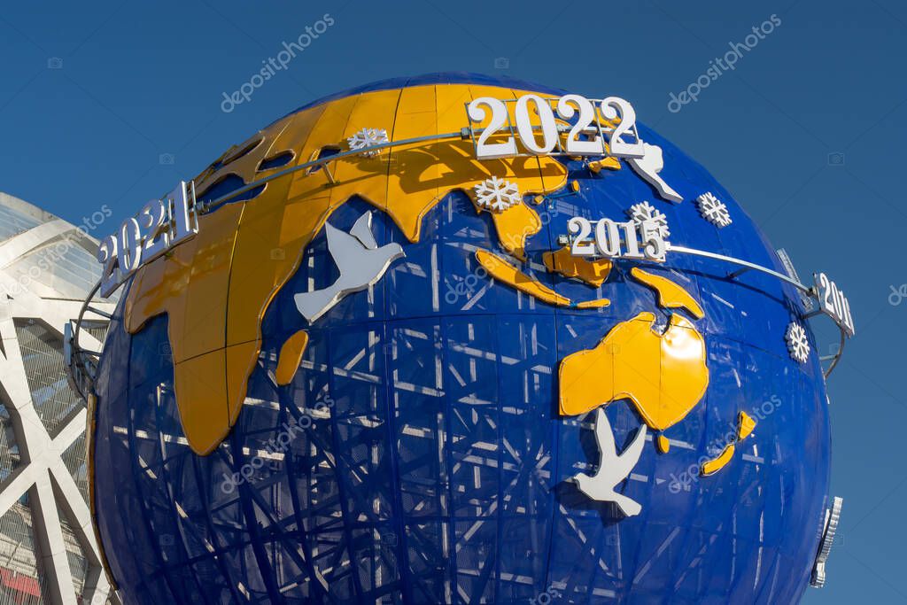 Beijing / China - February 20, 2016: Model of Earth with dates showing important Olympic events, promotion of the Beijing Winter Olympic Games 2022 in Olympic Green Park in Beijing, China