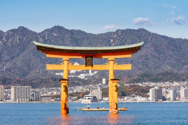 Miyajima, Hiroshima Prefecture / Japan - December 21, 2017: Itsukushima Shinto Shrine in Miyajima island with its floating red torii gate, UNESCO World Heritage Site in Hiroshima, Japan clipart