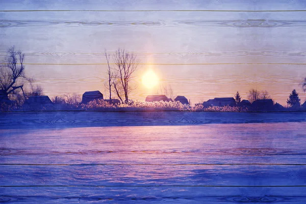 Display of winter background of rural nature on wooden surface, sunrise.