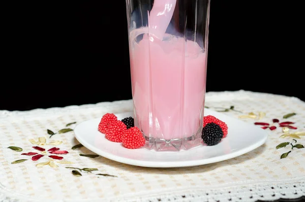 Pink drink with berries and cream for children