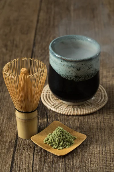 green tea matcha japanese drink traditional with wood background and hot smoke from tea