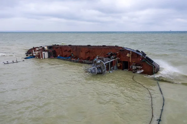Top view of sinking tanker shot by drone. Inverted tanker wrecked on Black Sea coast of Odessa. Empty tanker leaned to one side and ran aground by during storm with strong wind.