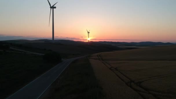 Highland 'da günbatımı gökyüzünde enerji üretimi için yel değirmenlerinin hava manzarası. Rüzgar güç türbinleri yenilenebilir temiz enerji üretiyor — Stok video