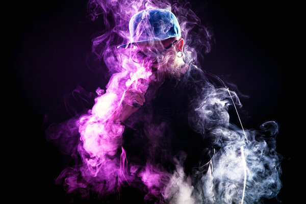 Man with beard  in sunglasses vaping