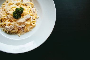 Siyah arka plan üzerine klasik makarna carbonara İtalyanca Parmesan peyniri ile