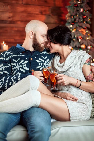 Beautiful couple sitting on the couch — Stock Photo, Image