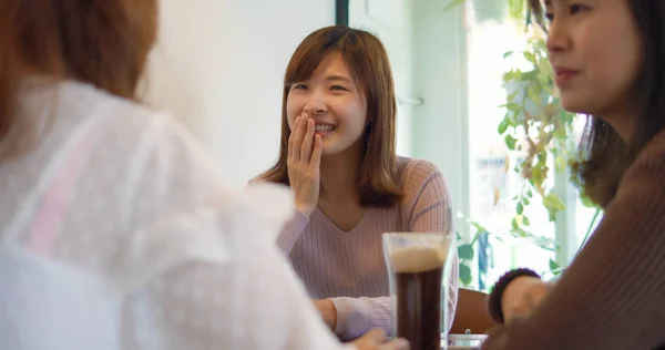 Asian Woman Chatting In Restaurant