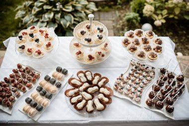 Krema ve böğürtlenlerle süslenmiş bir sürü kek.