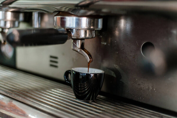 Close up of black mug on espresso machine