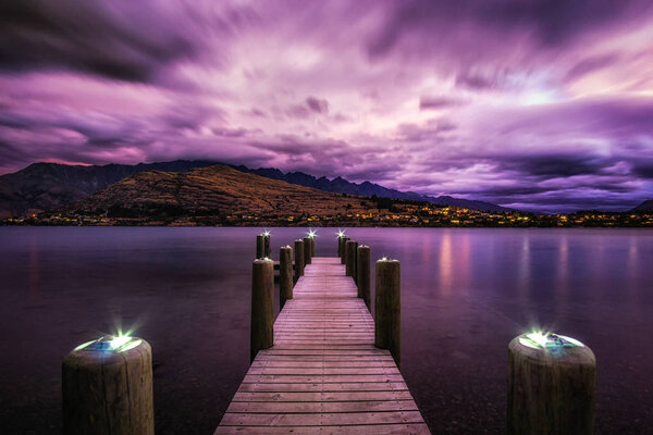 sunset with a dock in lake wakatipu