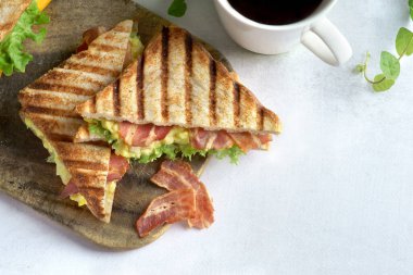 Hafif arka planda yumurta ve pastırmalı sandviç.