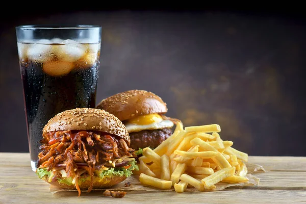 pulled pork Burger and egg cheeseburger with a glass of cola